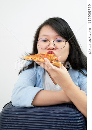 Happy glasses Asian young woman eat Pizza on white background. 116939759