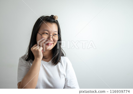 Asian Glassese Woman is touching her cheek and thinking somethings on white background in studio light. 116939774
