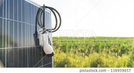 Close up of electric car charging plug with solar panel Close up of electric car charging plug with solar panel 116939857