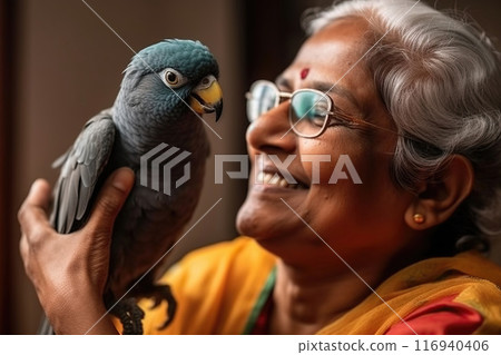 Joyful Elderly Woman Speaking With Her Colorful Parrot 116940406