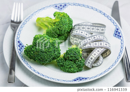 Concept of healthy eating and weight loss. Plate of broccoli. 116941339