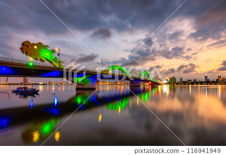 Dragon bridge in Danang at sunset which is a very famous destination for tourists Dragon bridge in Danang at sunset which is a very famous destination for tourists 116941949