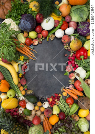 A frame of various vegetables, fruits and berries. Concept of fertility and good harvest, copy space 116942944