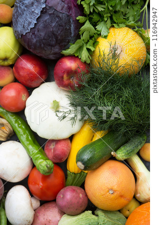 Plant background with ripe fruits, vegetables and herbs. Concept of fertility and good harvest, top view 116942947