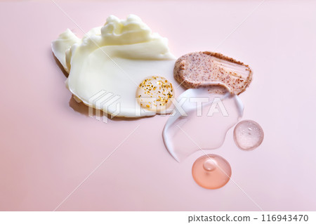 Different cosmetic textures on a delicate peach background.  116943470
