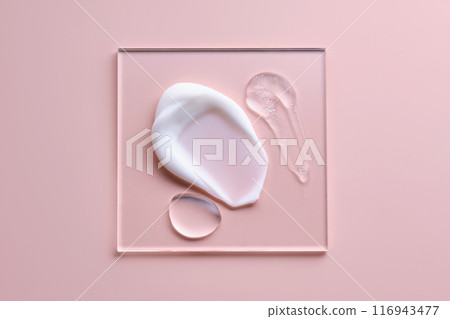 Textures of different cosmetic products on a pink background on a square transparent stand. Textures of different cosmetic products on a pink background on a square transparent stand. 116943477