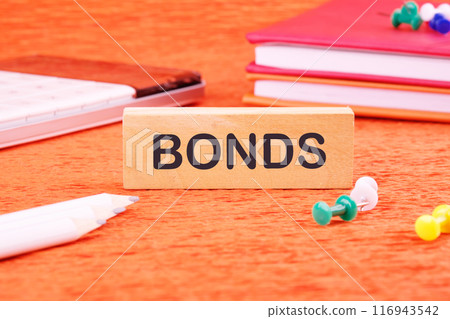 Unsecured and secured bonds. BONDS word on wooden blocks in front of an orange background 116943542