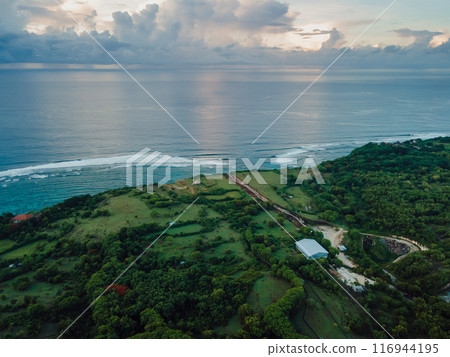 Panorama of Bali coastline with ocean and strong current on Green bowl beach. Aerial view Panorama of Bali coastline with ocean and strong current on Green bowl beach. Aerial view 116944195