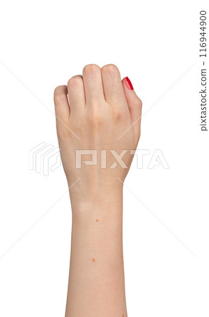 Female hand in a fist, showing knuckles with red manicured nails, dorsal view. Elegant gesture, 116944900
