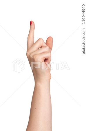 Index finger pointing to indicate direction, with red nail varnish on a Caucasian woman's right hand 116944940