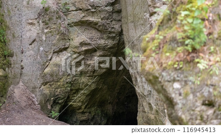 Engraved Cave Entrance in Rocky Terrain 116945413
