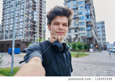 Selfie portrait of young handsome man with curly hair, outdoor Selfie portrait of young handsome man with curly hair, outdoor 116945494