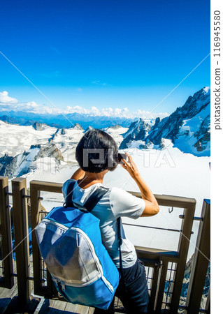 Tourist on viewpoint in alpine mountains Tourist on viewpoint in alpine mountains 116945580