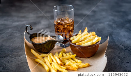 Tasty french fries with drink and sauce Tasty french fries with drink and sauce 116945652