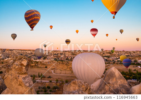 Hot air balloons in sunset sky 116945663