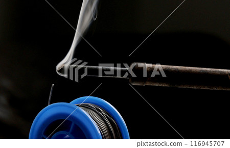 Soldering iron melts tin 116945707