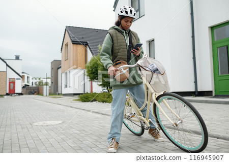 Pretty teenager sitting on bicycle 116945907