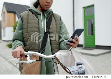 Girl in casualwear using smartphone 116945910
