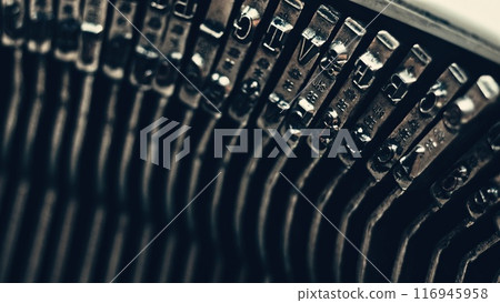 Letters and numbers on typo keys of an old manual typewriter 116945958