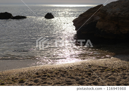 stones in the water near the seashore on the beach at sunset stones in the water near the seashore on the beach at sunset 116945988