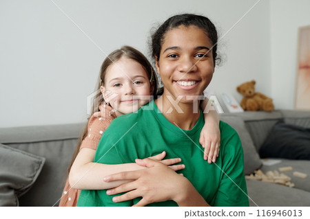 Teenage sitter and affectionate girl Teenage sitter and affectionate girl 116946013