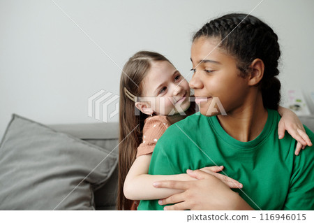 Little girl looking at smiling sitter Little girl looking at smiling sitter 116946015