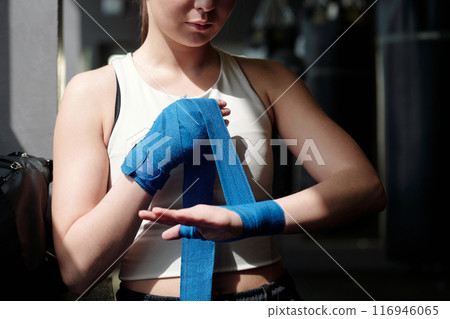Woman preparing for boxing training Woman preparing for boxing training 116946065