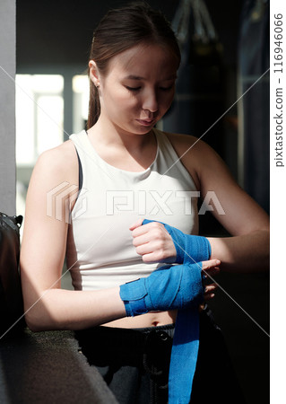Wrapping wrists with blue flexible band 116946066