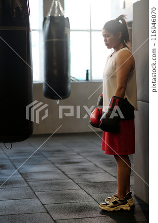 Young tired female boxer in sportswear Young tired female boxer in sportswear 116946070