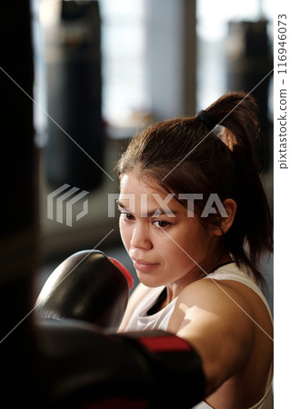 Kick practice in front of punching bag Kick practice in front of punching bag 116946073