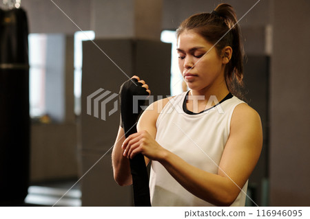Girl putting protective band around hand 116946095