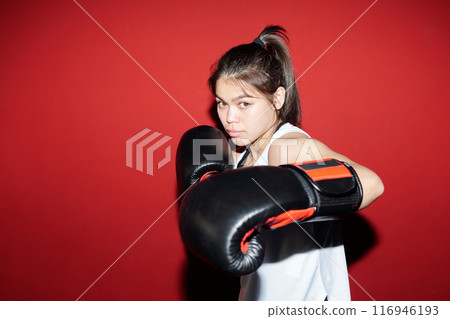 Active girl practicing defense exercises Active girl practicing defense exercises 116946193
