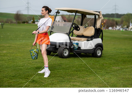 Sporty woman playing with vigor on the green field Sporty woman playing with vigor on the green field 116946547
