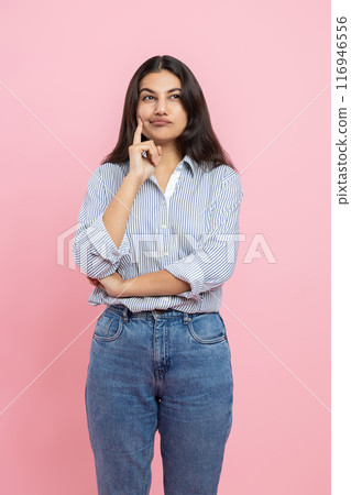 Thoughtful Indian woman holding chin thinking 116946556