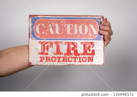 Fire Protection. Caution sign with text in hand Fire Protection. Caution sign with text in hand 116946572