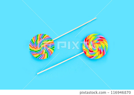 Rainbow lollipop on blue background. Rainbow lollipop on blue background. 116946870