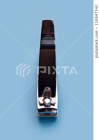 Nail clippers on blue background. 116947142