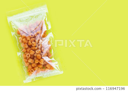 Package with dried longan on green background. Package with dried longan on green background. 116947196