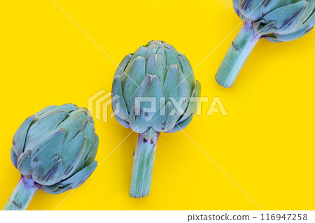 Fresh artichoke on yellow background. Fresh artichoke on yellow background. 116947258