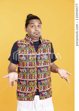 Portrait of doubtful man shrugging shoulders, unable to provide answer, isolated over studio background. Hesitant person doing perplexed hand gesturing, showing lack of knowledge Portrait of doubtful man shrugging shoulders, unable to provide answer, isolated over studio background. Hesitant person doing perplexed hand gesturing, showing lack of knowledge 116948477