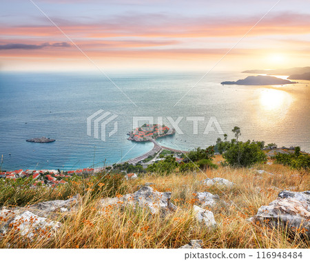 Captivating sunset view of Adriatic coast and islet Sveti Stefan from church st. Sava viewpoint near Budwa 116948484