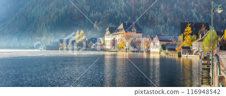 Stunning foggy autumn sunrise on famous Hallstatt mountain village with Hallstatter lake. Stunning foggy autumn sunrise on famous Hallstatt mountain village with Hallstatter lake. 116948542