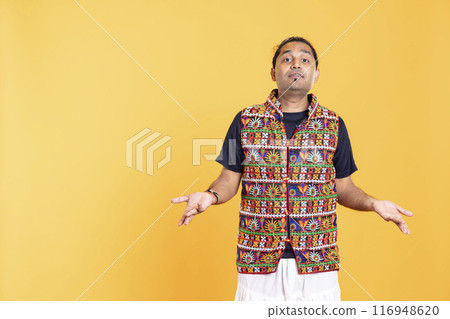 Portrait of perplexed man shrugging shoulders, hesitant to provide answer. Confused person doing questioning hand gesture, showing lack of knowledge, feeling indecisive, studio backdrop 116948620