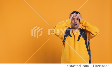 Overloaded delivery man carrying huge stack of pizza boxes, worried after making mistake. Worker encumbered by too many food orders, dropping them, feeling upset, studio background, camera B Overloaded delivery man carrying huge stack of pizza boxes, worried after making mistake. Worker encumbered by too many food orders, dropping them, feeling upset, studio background, camera B 116948658
