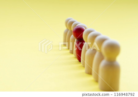 A red wooden figure looking as if he or she is disagreed with something. Concept of courage and speak up. A red wooden figure looking as if he or she is disagreed with something. Concept of courage and speak up. 116948792
