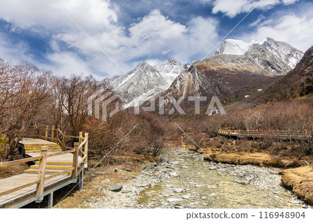 Panaromic view of the scenic and breathtaking Yading nature reserve luorong pasture, located in Garze Tibetan Autonomous Prefecture, Sichuan with boardwalk. 116948904