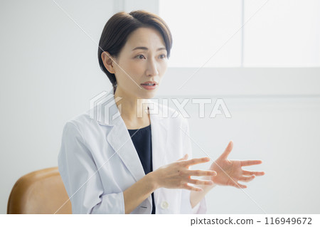 Smiling woman in a white coat 116949672