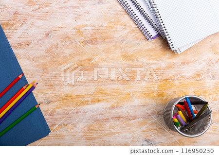 Pencils and workbooks on wooden desk 116950230