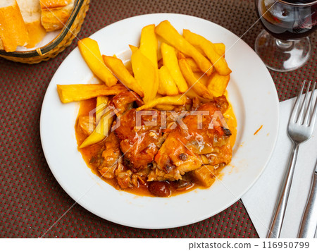 Braised rabbit served with potato garnish Braised rabbit served with potato garnish 116950799