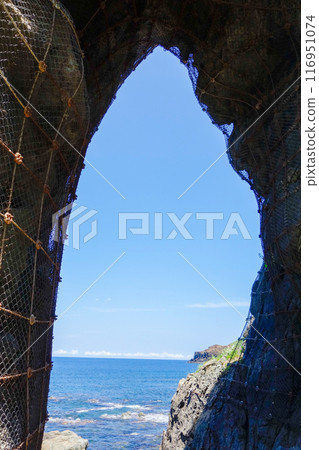 View of the ocean from a cave (vertical) View of the ocean from a cave (vertical) 116951074